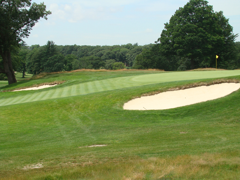As seen from the side, approach shots that come up just short will likely roll thirty yards back down the hill. 