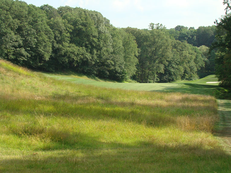 Job 1 is to find the fairway. A fifty foot - no kidding - granite cliff looms right of fairway, so plenty of golfers shy away and use the hard left to right slope to kick their ball down the fairway.